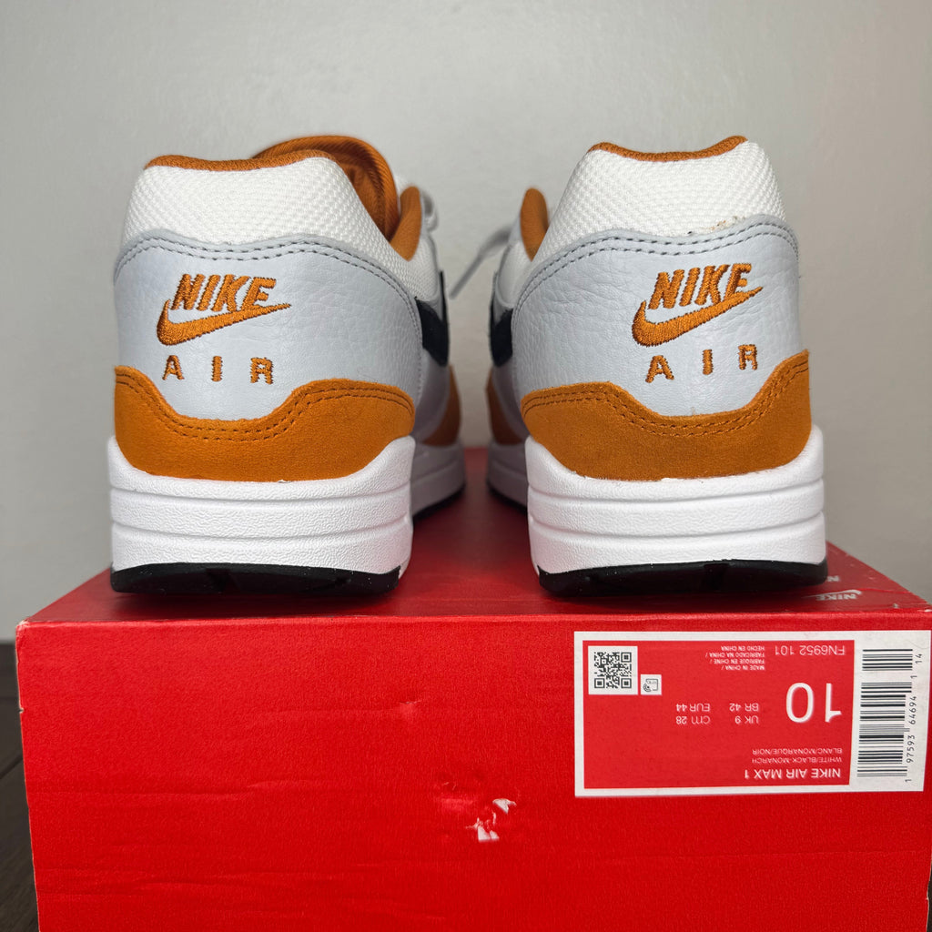 Pair of Nike Air shoes on a red box with a gray background