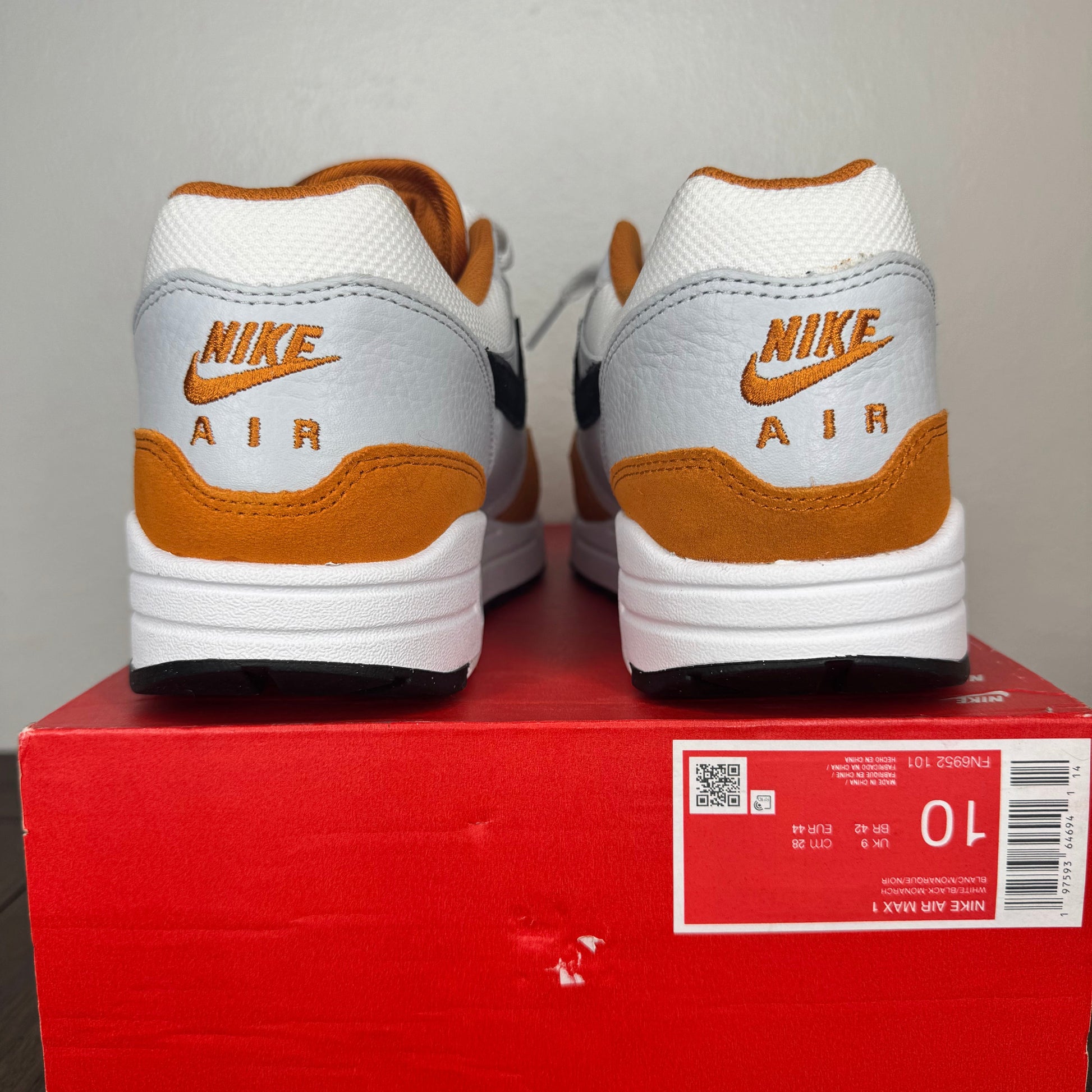 Pair of Nike Air shoes on a red box with a gray background